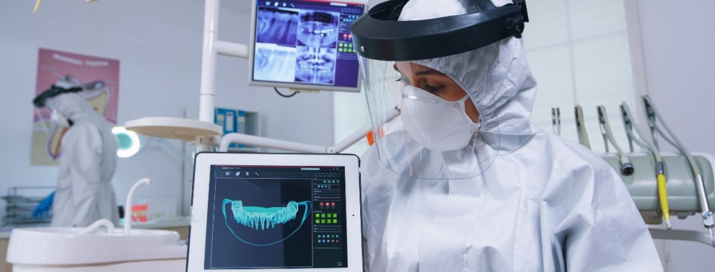 Young female dentist showing a patient a dental xray Dentistry concept