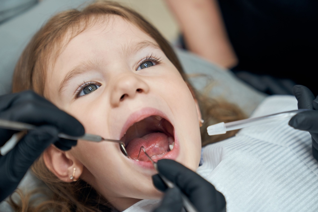 Dentist Examining Condition of Teeth of Little Patient